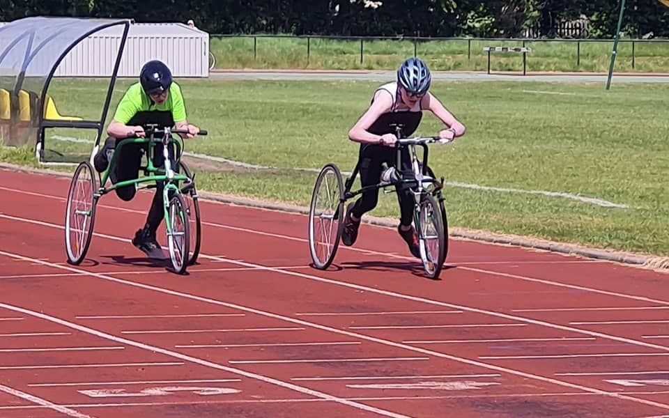 Ian and Ben racing down athletic track