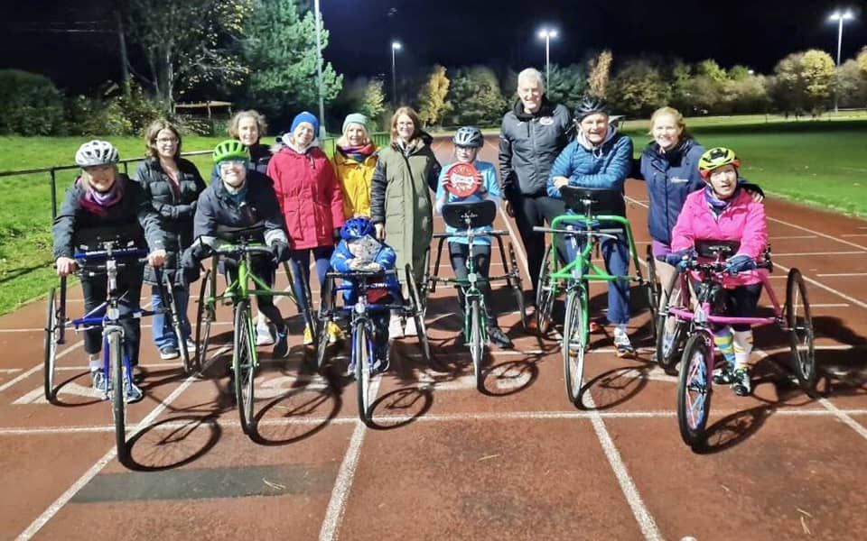 group photo of frame runners on athletics track
