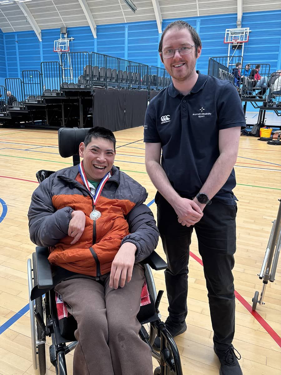Ricco with a huge smile wearing a medal